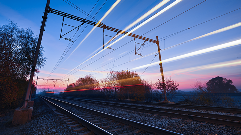 Intermodal transport: railway tracks in the sunset with dynamic lines Intermodal transport: railway tracks in the sunset with dynamic lines