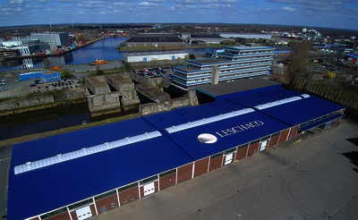 Aerial photo of warehouse with blue roof and white Leschaco logo